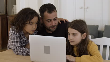 Alleinerziehender-Vater-Lernt-Mit-Kindern-Am-Laptop.